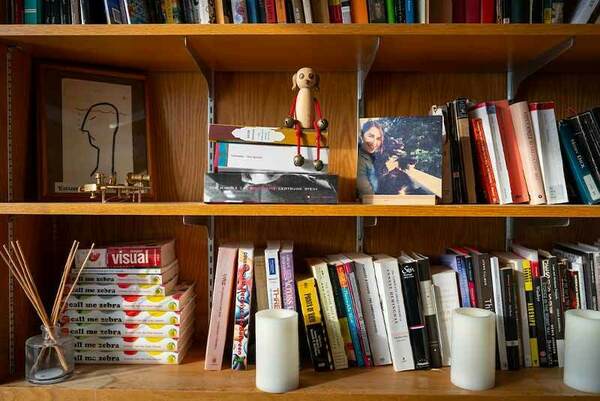 Books and personal knick knacks on a book shelf.